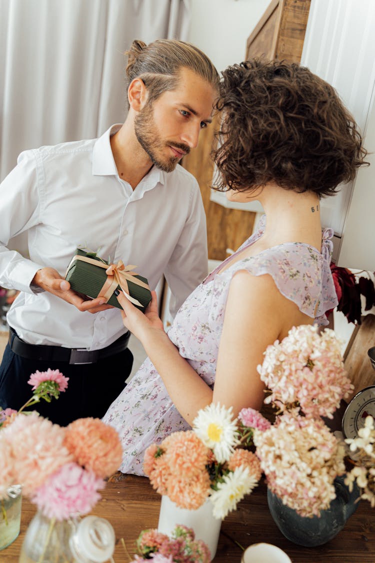 Bearded Man Giving Gift To A Woman