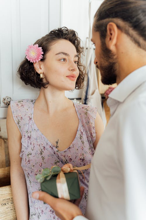 Free Woman in Floral Dress Looking at a Bearded Man Stock Photo