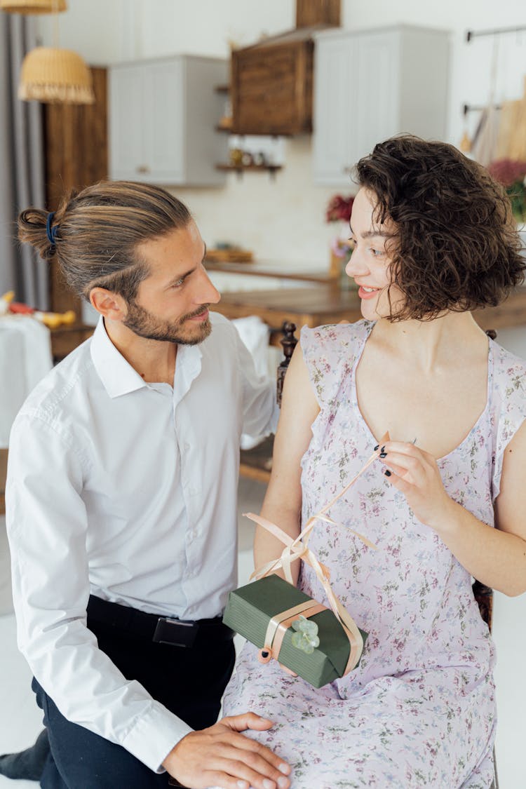 A Woman Opening An Anniversary Gift