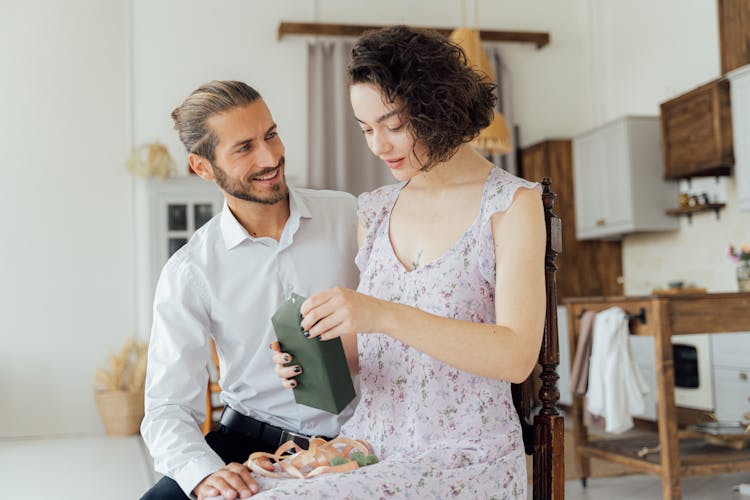 A Woman Opening A Present