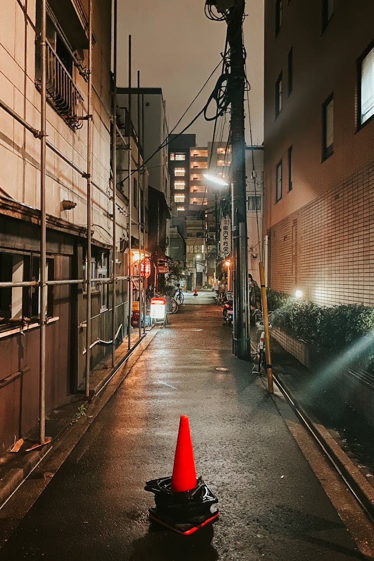 Traffic Cone In A Narrow Tokyo Alley