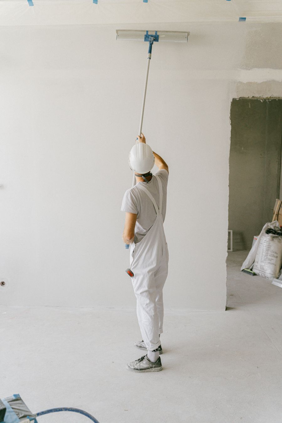 Painter applying a fresh coat to an interior wall
