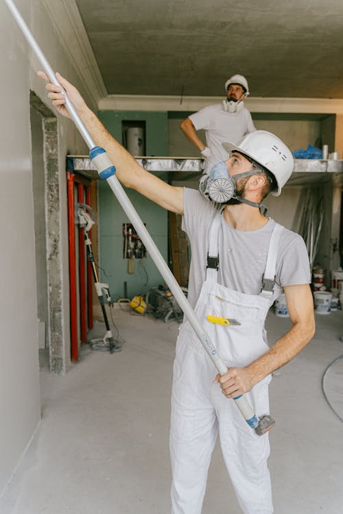 Free Construction Workers Renovating a House Stock Photo