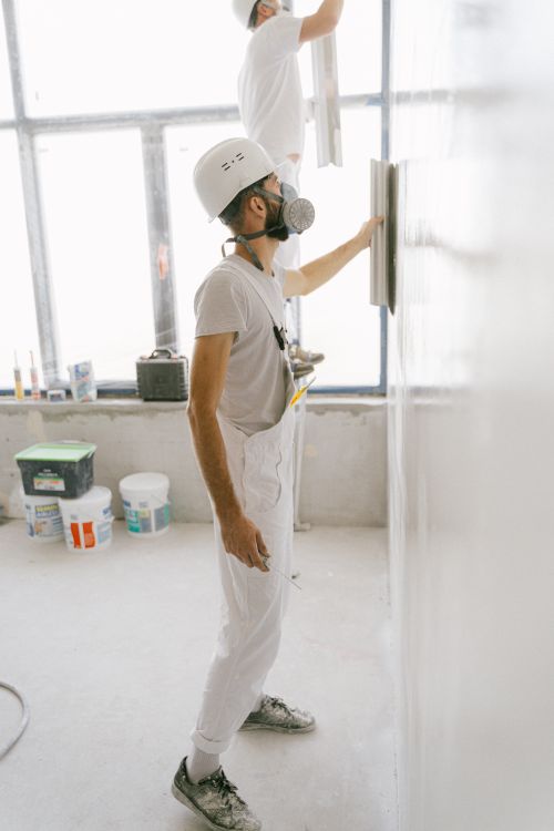 Construction workers plastering a wall