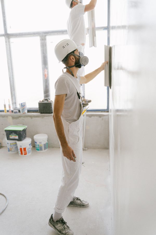 Construction workers on a house wall