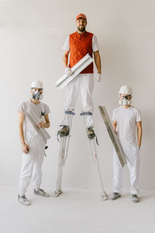 Restoration crew in uniforms and hard hats working inside a building