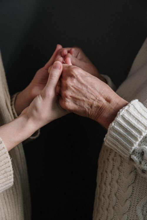 Free Two generations connect through holding hands, symbolizing love and unity. Stock Photo