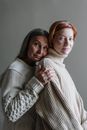 Woman in White Turtleneck Sweater Hugging Woman in White Sweater