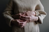 Woman in Brown Sweater Holding Baby