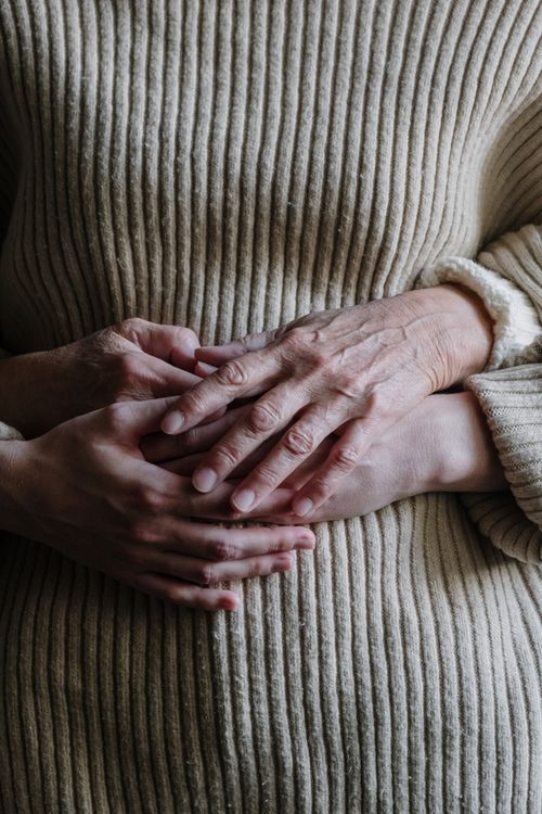 Free Close-up of two pairs of hands representing connection and comfort. Stock Photo