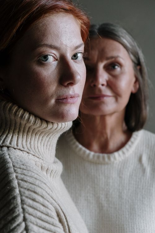 Free A close-up portrait of two women in cozy sweaters, showcasing natural beauty and connection. Stock Photo
