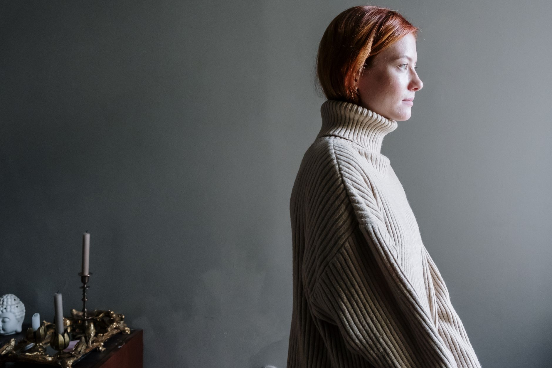 A folded cashmere jumper in soft natural light