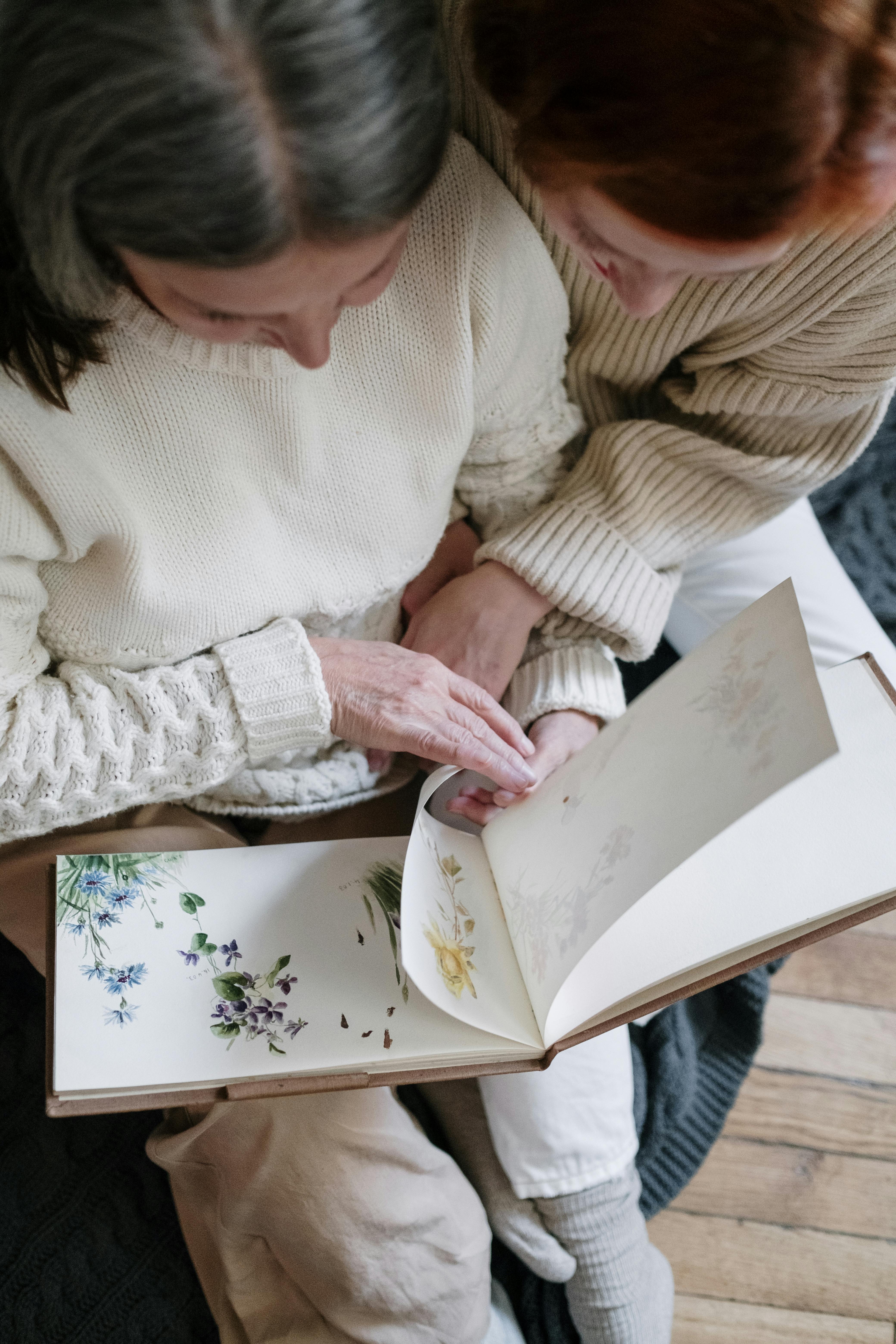 mother and daughter looking at a book