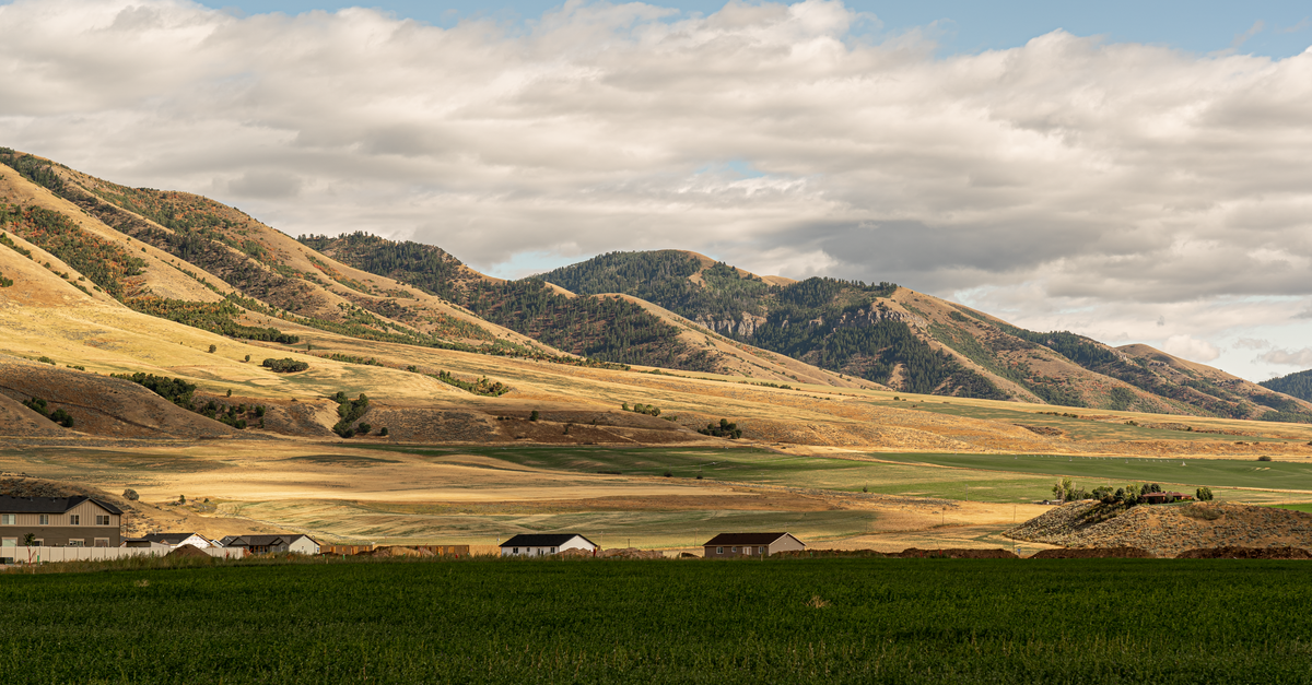 Breathtaking view of Hyrum, Utah's rolling hills under a cloudy sky, showcasing rural tranquility.