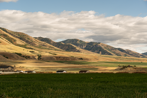 Free Breathtaking view of Hyrum, Utah's rolling hills under a cloudy sky, showcasing rural tranquility. Stock Photo