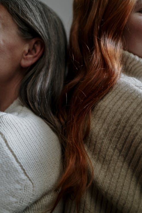 Free Gray Haired and Redhead Woman Leaning Back to Back Stock Photo