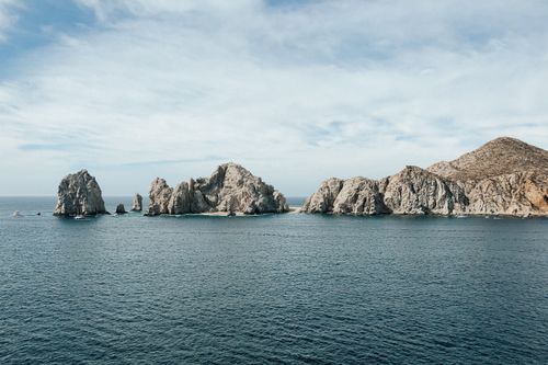 Free Stunning seascape of Cabo San Lucas with iconic rock formations under a clear blue sky. Stock Photo