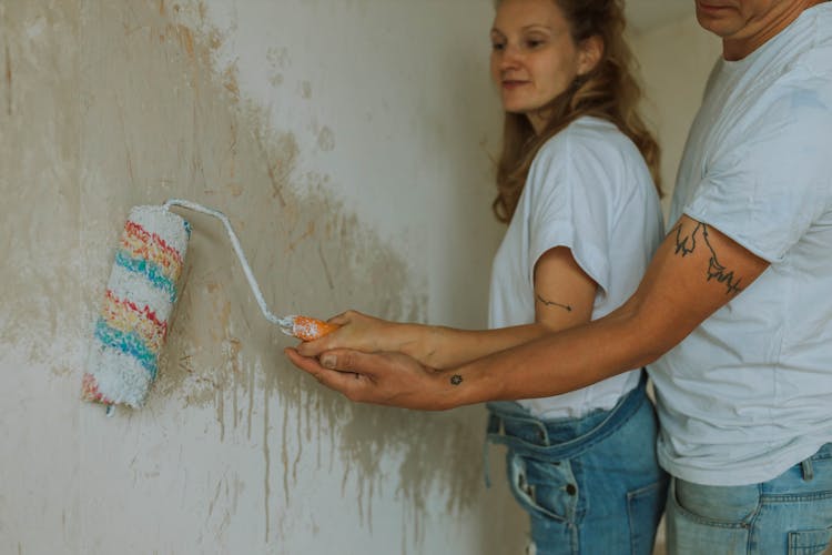 A Couple Painting A Wall