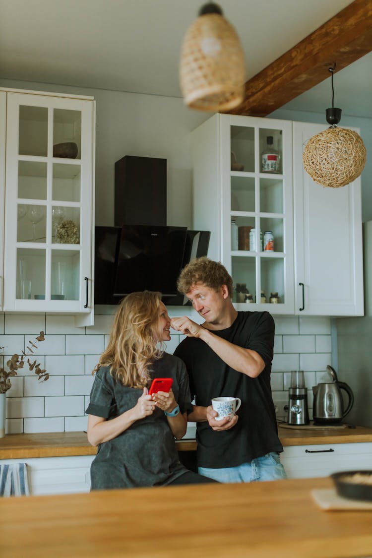 Couple Standing In The Kitchen