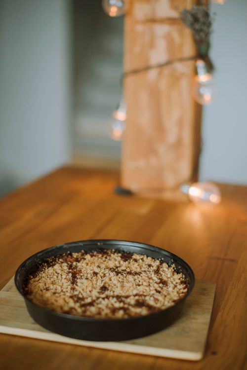Free Close-up of a homemade apple crumble pie on a wooden table, perfect for cozy gatherings. Stock Photo