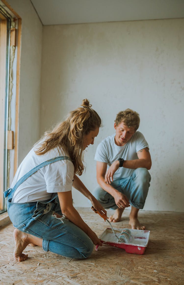 Couple Painting The House Together