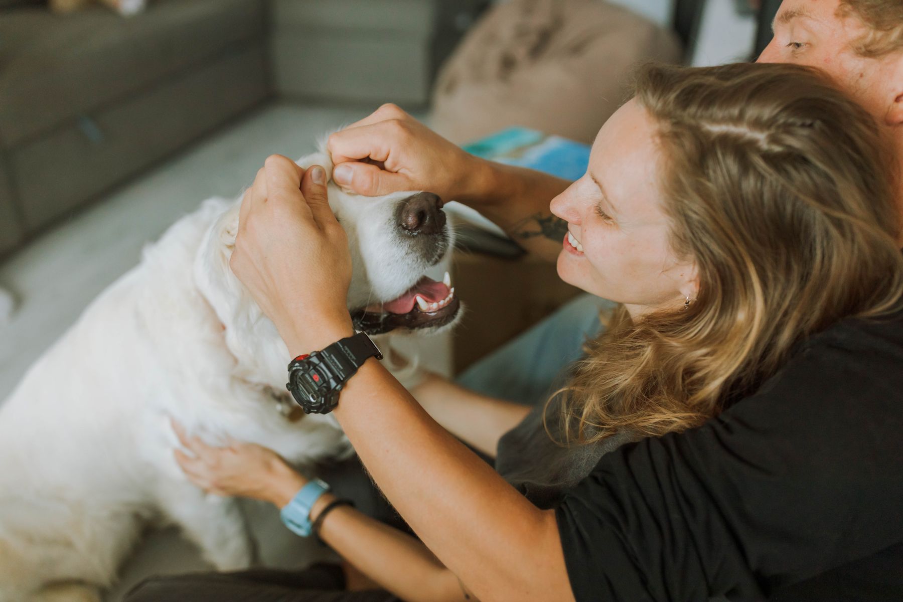 Happy pet parents enjoying time with their Golden Retriever