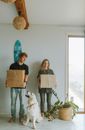 Woman in Black Shirt Holding Brown Cardboard Box