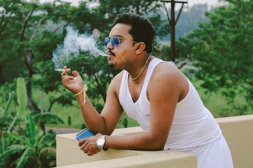 Man in White Tank Top Smoking