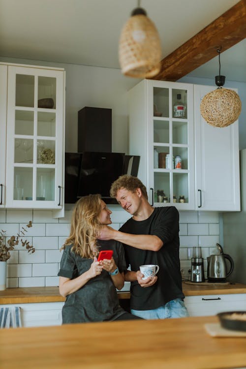 Man in Black Shirt Holding Woman's Neck