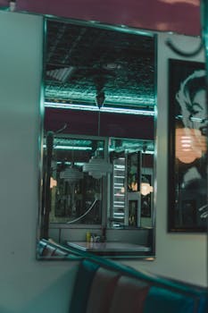A classic teal-themed diner interior with neon reflections and vintage decor.
