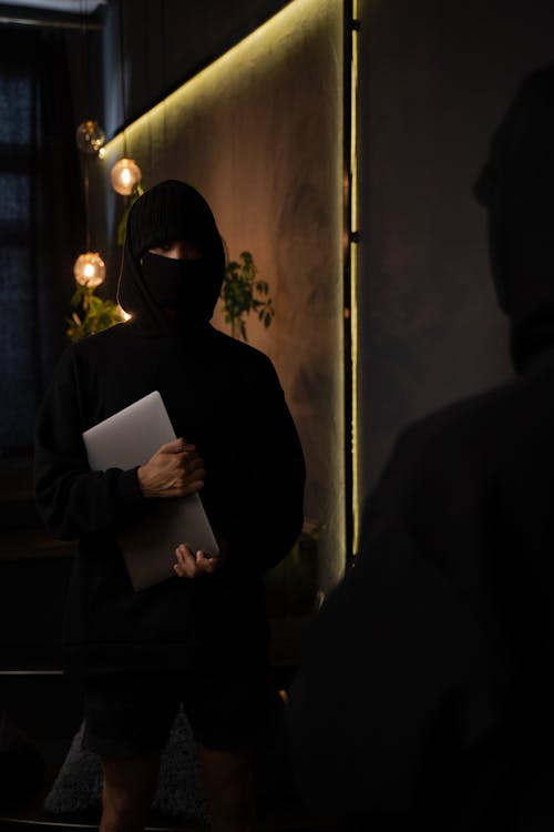 Free Man in Black Long Sleeve Shirt Holding a Laptop Stock Photo