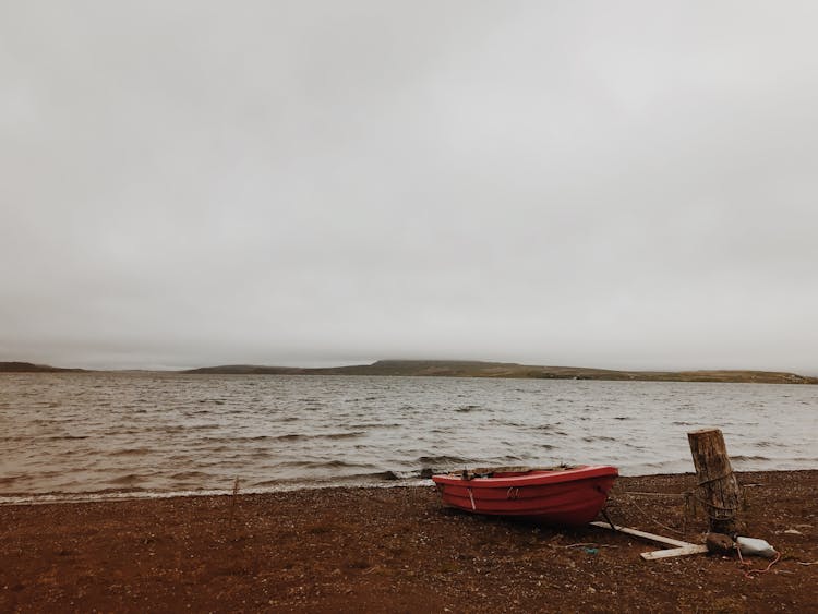 Red Boat On Brown Sand Near Sea