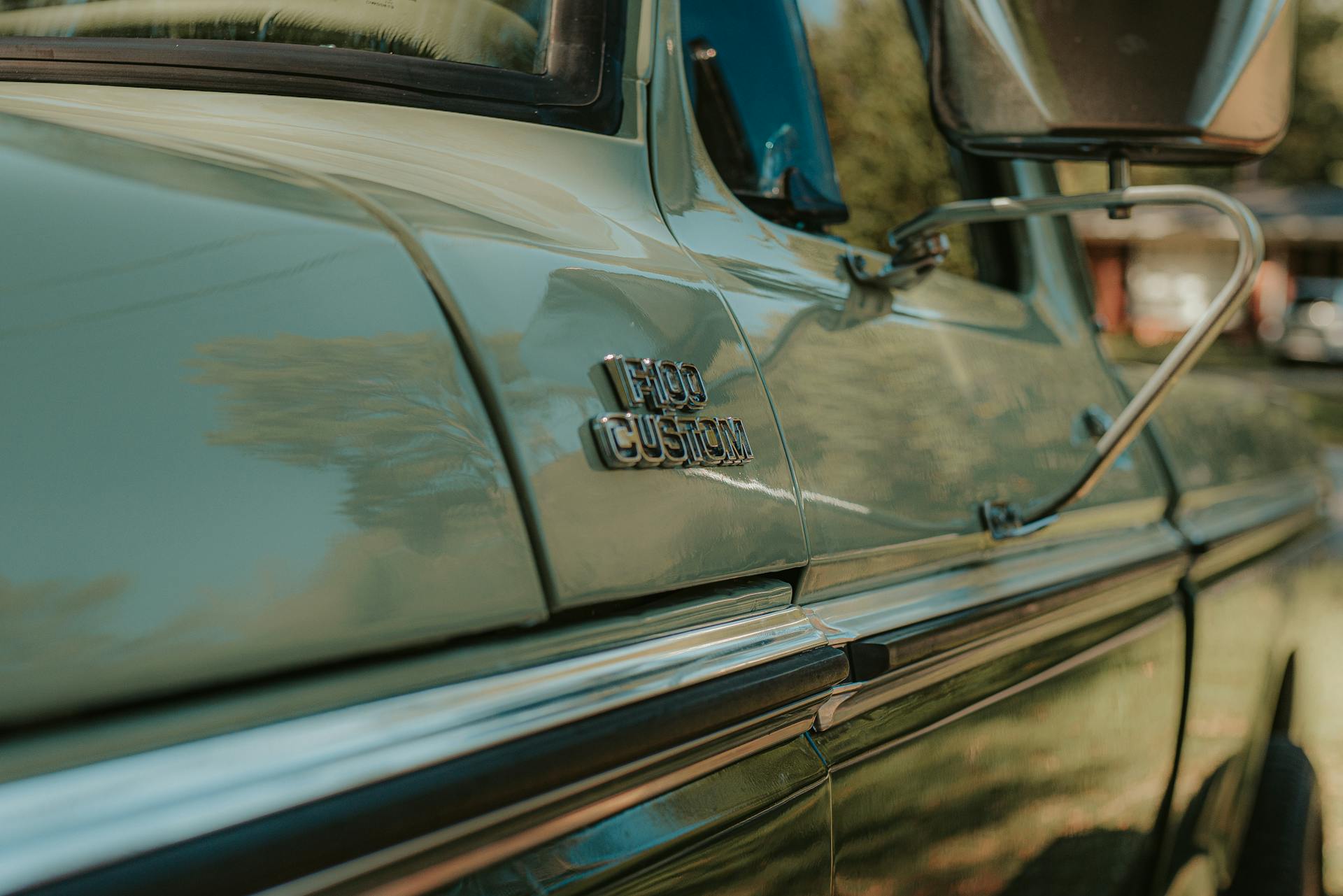Stylish exterior of old fashioned pickup car of light green car parked on sunny street
