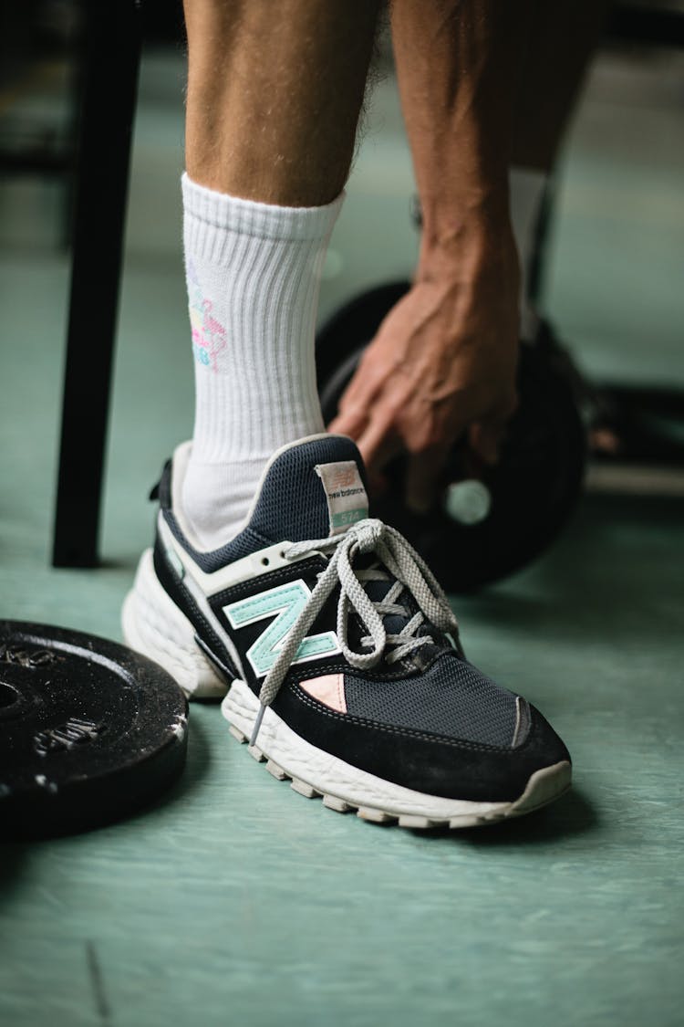 Crop Man Legs In Gym With Dumbbells