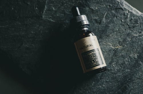 Free CBD Bottle on Black Background Stock Photo