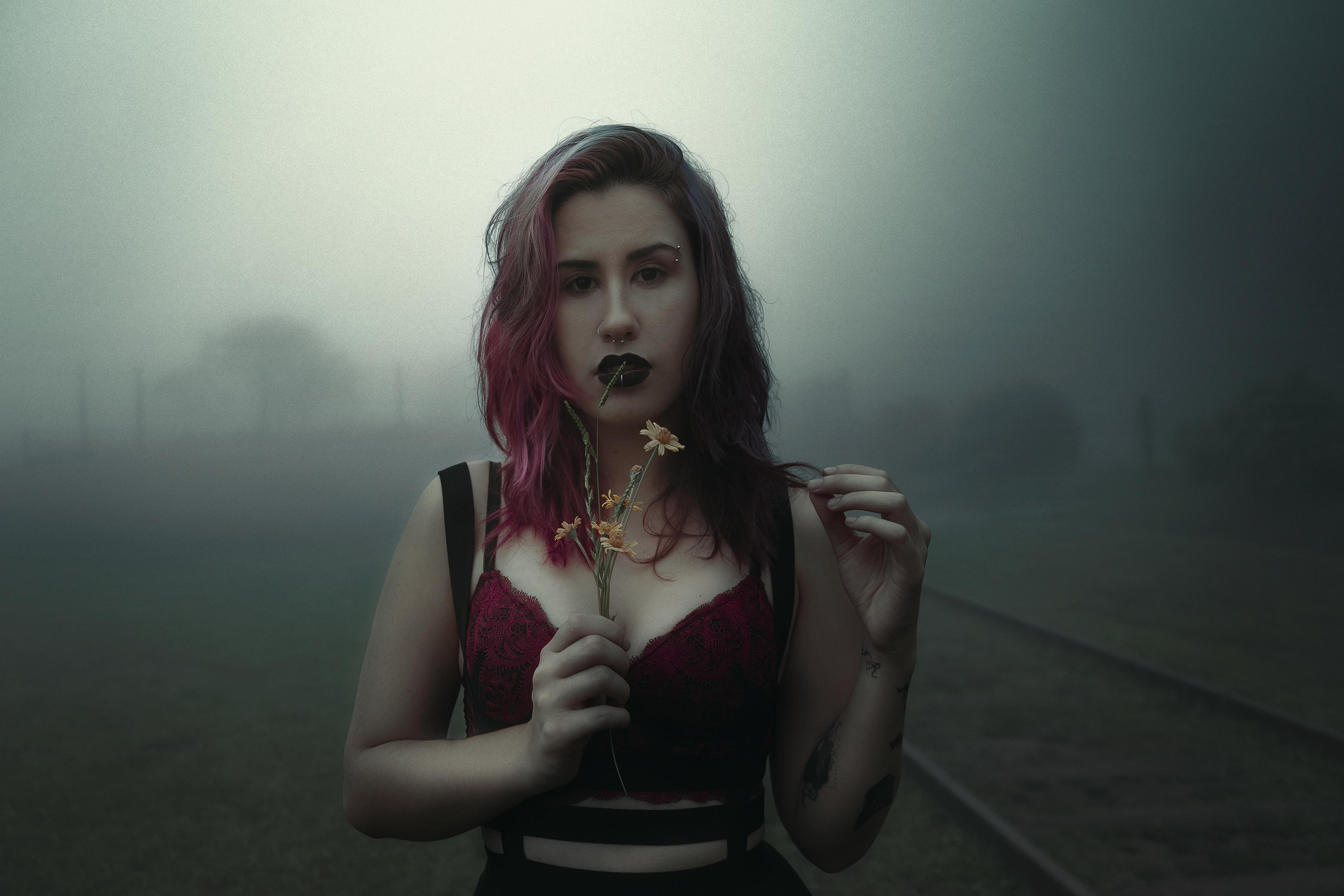 Woman with Pink Hair Holding Flowers