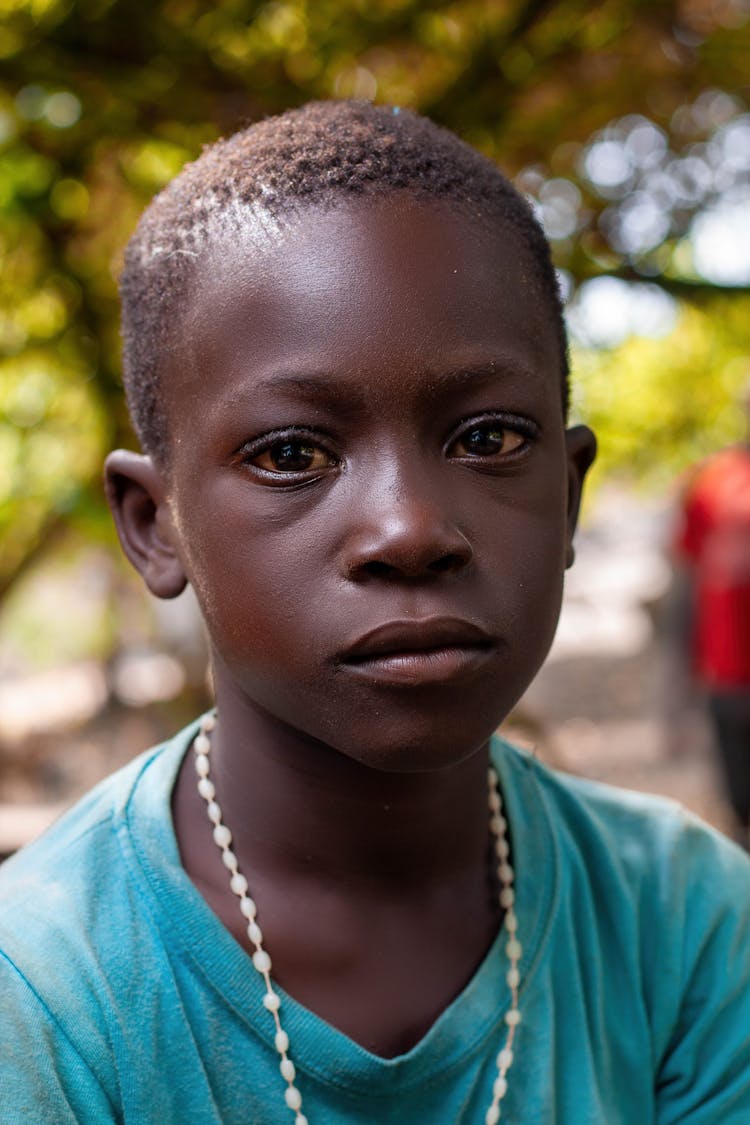 Portrait Of A Boy Wearing A Rosary On His Neck 