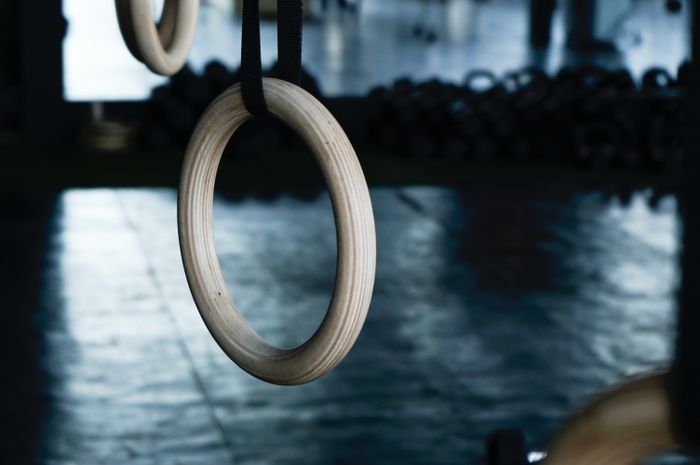 Dimly lit gym floor with training equipment — photo by Eduardo Cano Photo Co. on Pexels