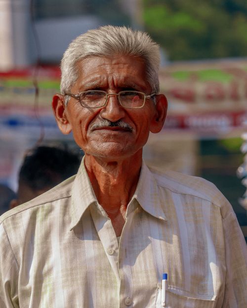 Free Elderly man with glasses and moustache smiling in Mysuru, India. Stock Photo