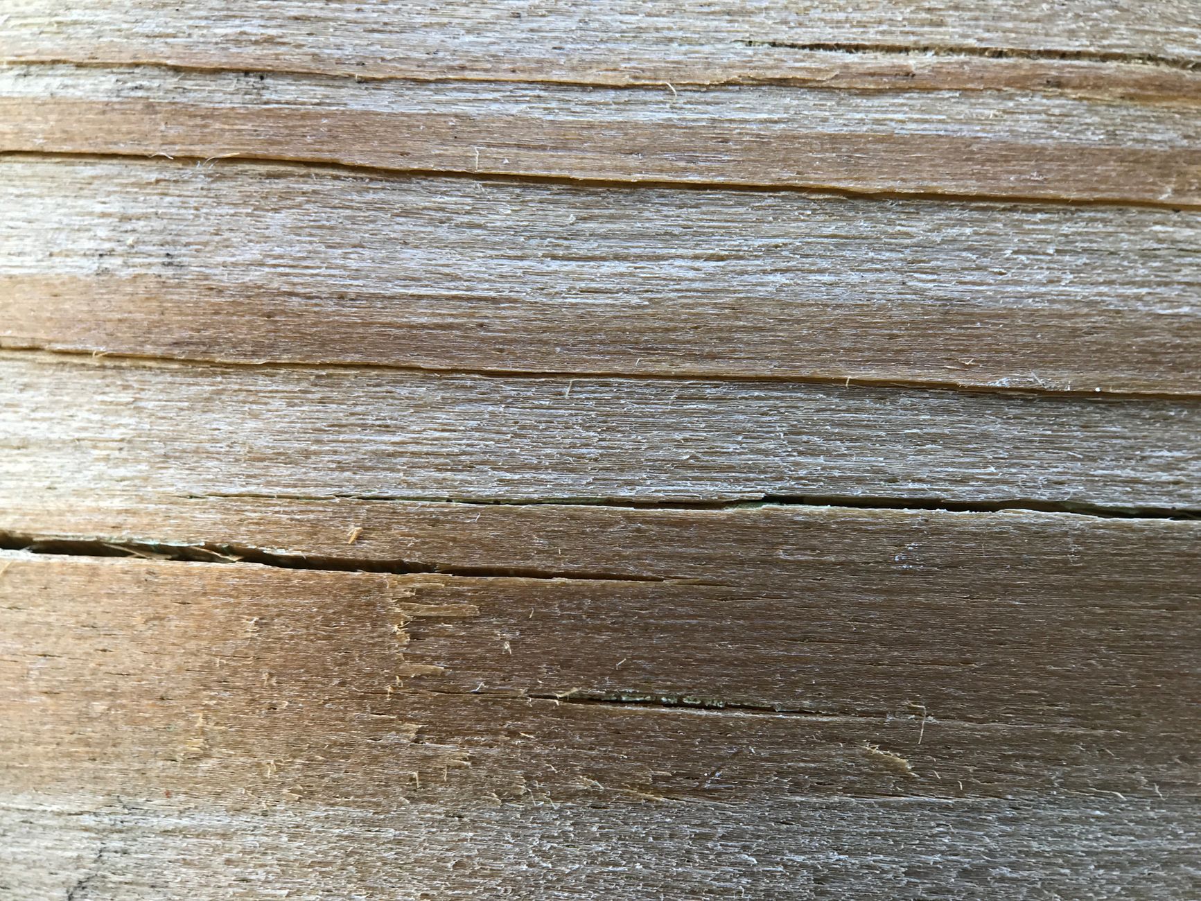 Detailed close-up of a rough wooden plank showcasing texture and natural patterns.