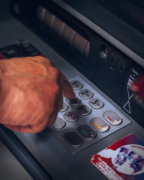 Person Pressing Keys of an ATM
