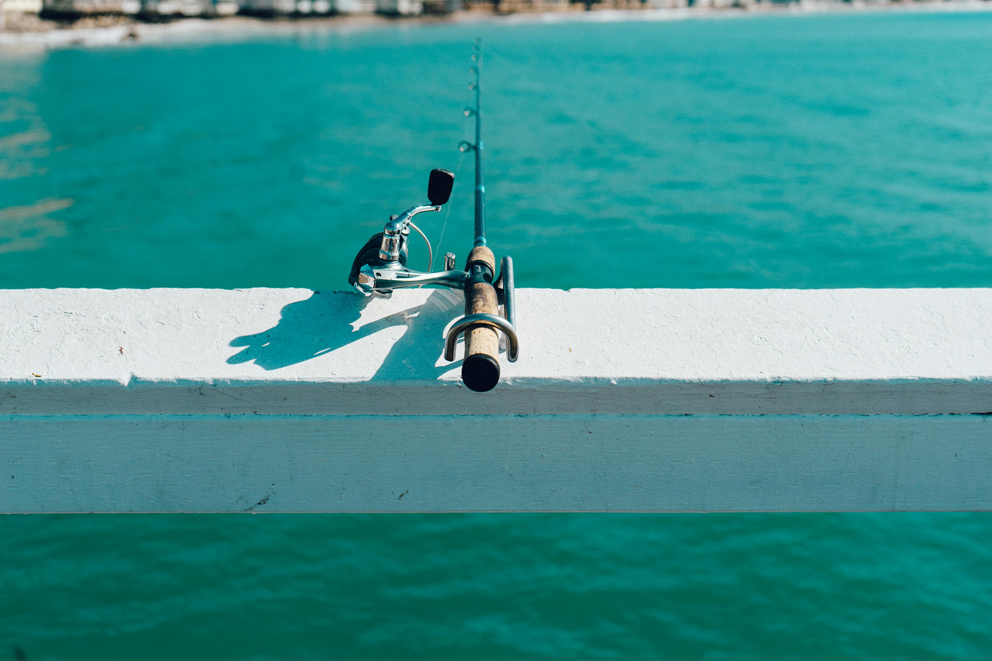 Fishing rod on white wooden surface