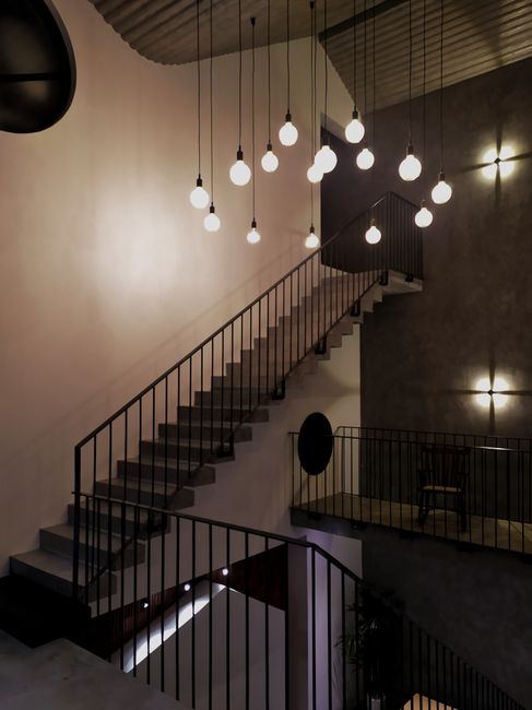 Photo by Kien Tran on Pexels Interior view of a modern staircase with hanging lights in a minimalist design, located in Đà Nẵng, Vietnam.