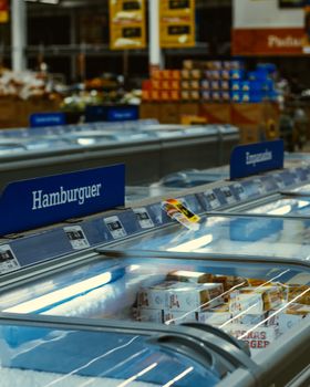 Chilled aisle of a Brazilian supermarket with various frozen foods on display.