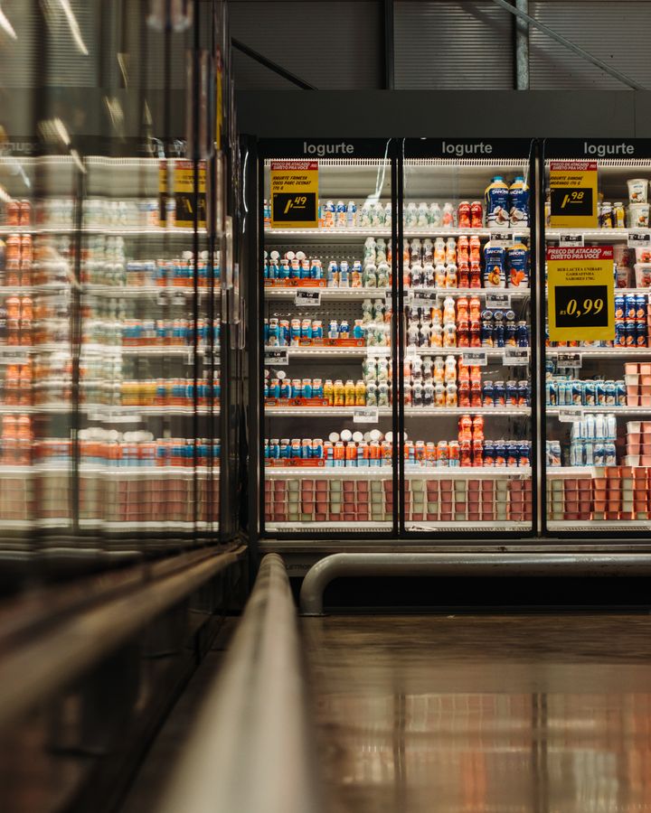 Refrigerated yogurt products on a supermarket dairy shelf