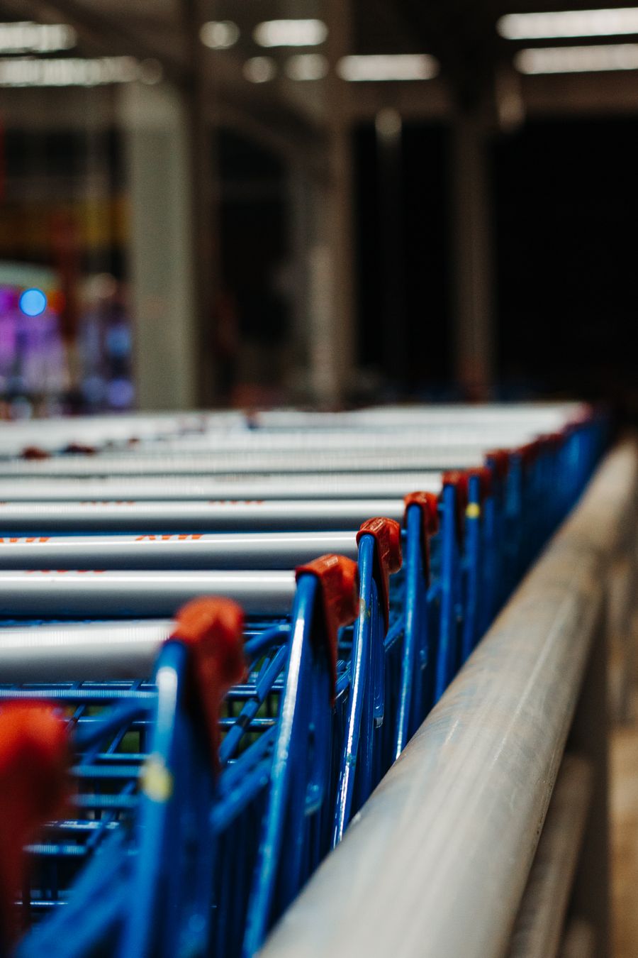 A row of shopping trolleys at a supermarket entrance