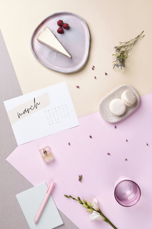 Top View of a Calendar and Cakes on a Pastel Table