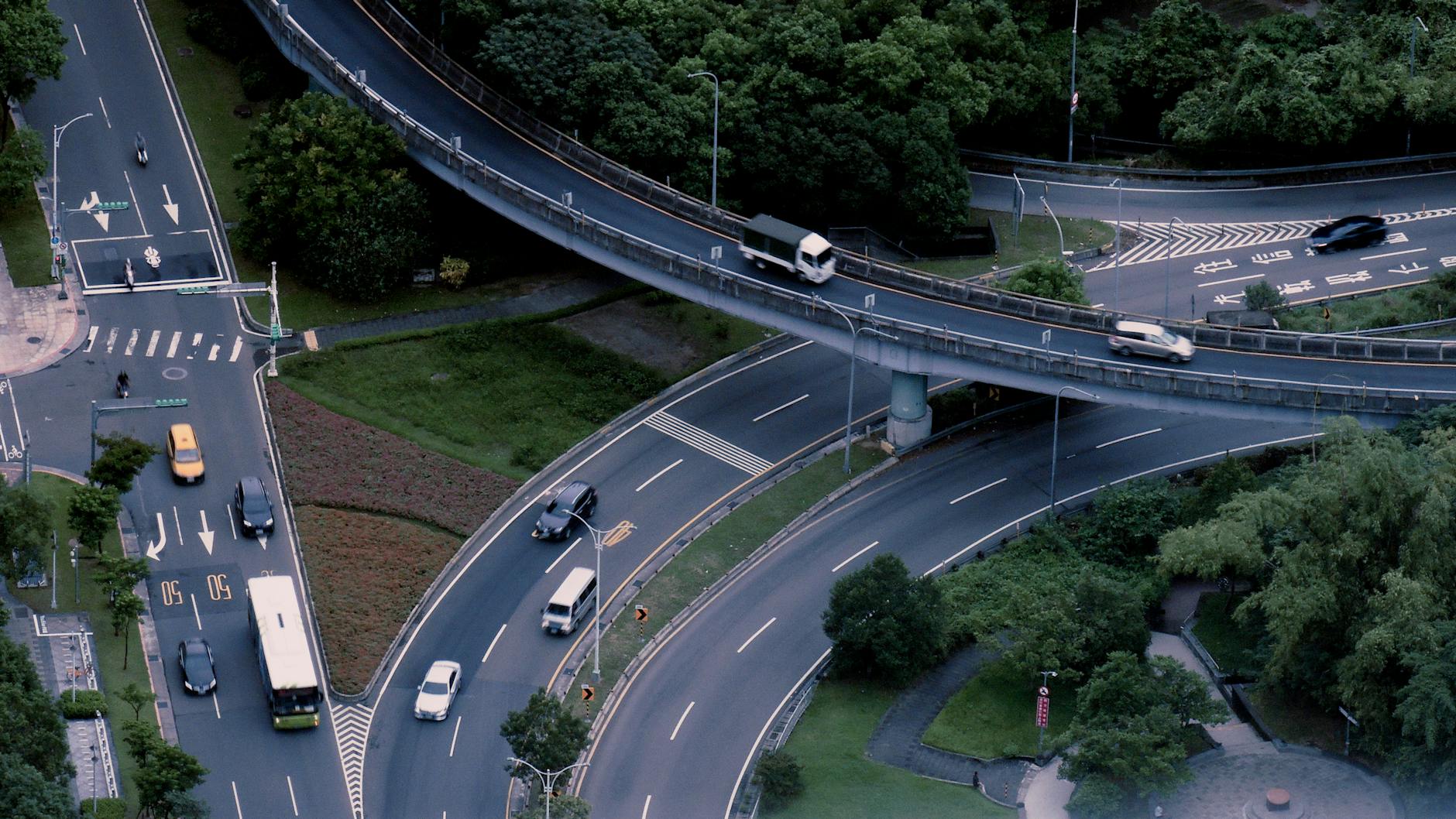 Aerial view of a busy urban intersection with multi-level roads and traffic.