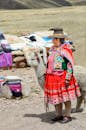 Photo of a Woman Standing with an Alpaca