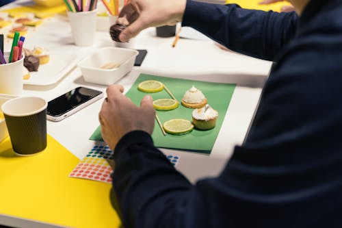 Person Decorating Cupcakes 